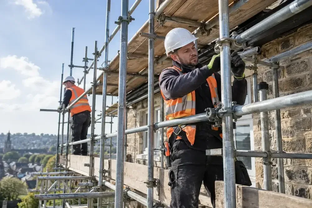 Scaffolder tightening fittings on an exterior tube scaffold